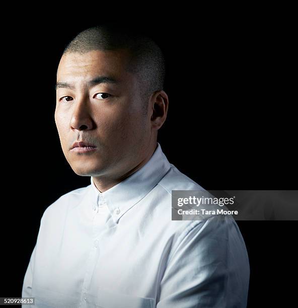 portrait of japanese man looking to camera - portrait black background stock pictures, royalty-free photos & images