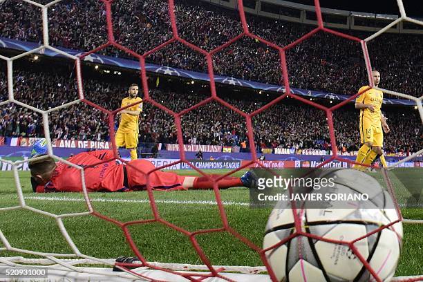 Barcelona's German goalkeeper Marc-Andre Ter Stegen lies on the field after a goal by Atletico Madrid's French forward Antoine Griezmann during the...
