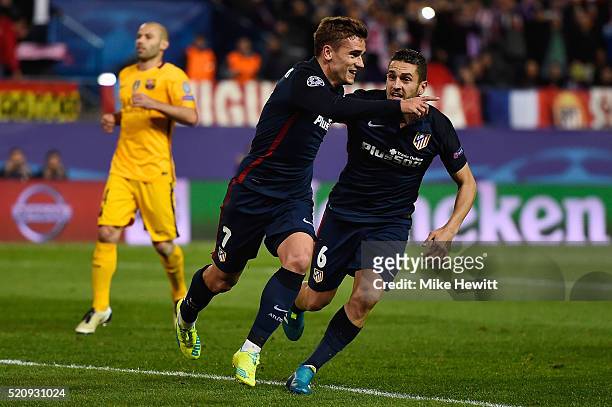 Antoine Griezmann of Atletico Madrid celebrates scoring his penalty with Koke for his team's second goal during the UEFA Champions League quarter...