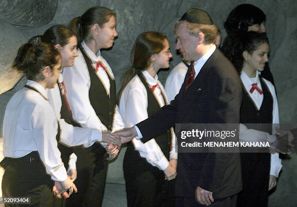 German President Horst Koehler shakes hands with members of the Israeli chorus at the remembrance hall of Jerusalem's Yad Vashem Holocaust Memorial...