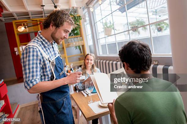 waiter working at a restaurant - menu stock pictures, royalty-free photos & images