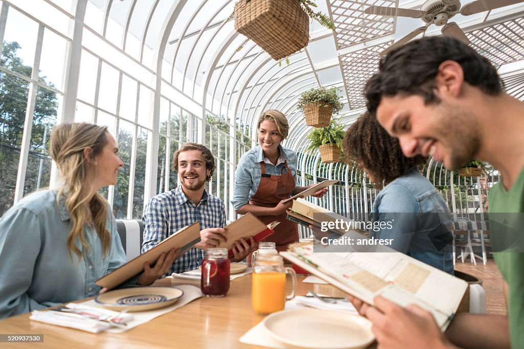 Waitress serving friends at a restaurant