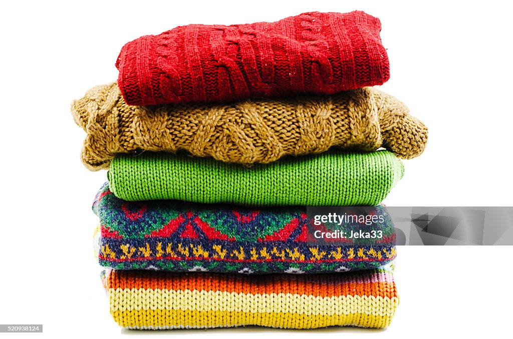 Stack of various sweaters. Winter style