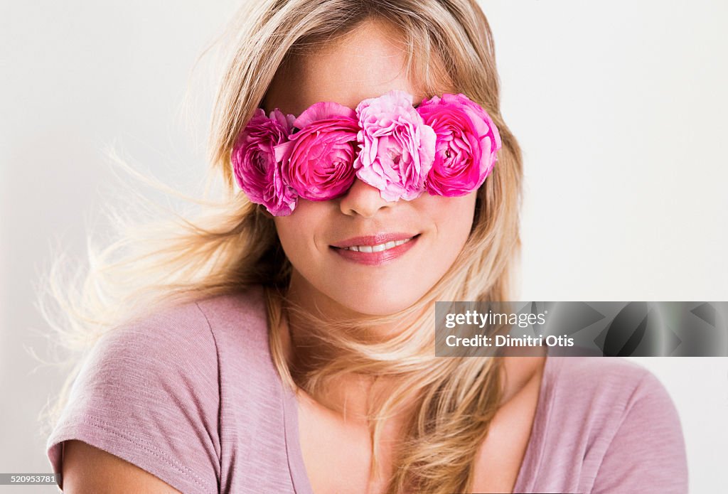 Young woman wearing floral mask over her eyes