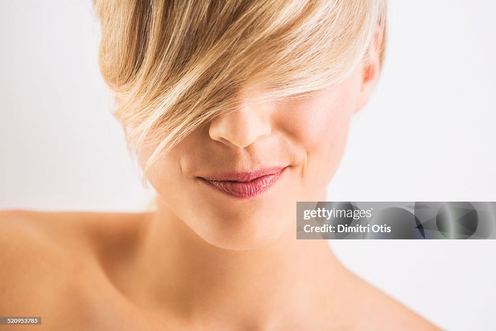 Close-up of blonde woman with quirky smile