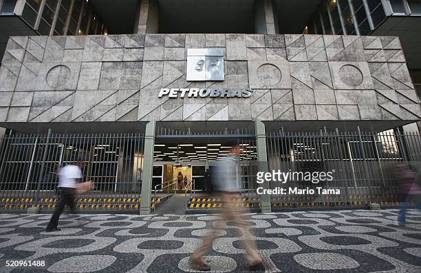 People walk past Petrobras headquarters on April 13, 2016 in Rio de Janeiro, Brazil. A massive corruption scandal at the state-owned oil company has...