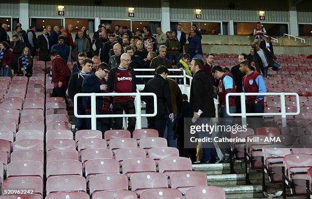 West Ham fans leave the stadium after the Emirates FA Cup Sixth Round Replay match between West Ham United and Manchester United at Boleyn Ground on...