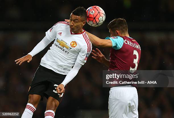 Jesse Lingard of Manchester United and Aaron Cresswell of West Ham United during the Emirates FA Cup Sixth Round Replay match between West Ham United...