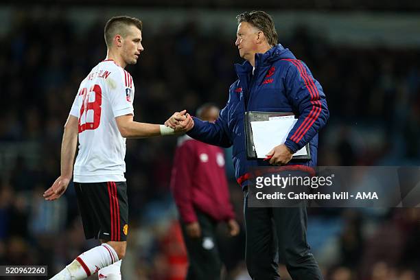 Louis van Gaal Manager of Manchester United and Morgan Schneiderlin of Manchester United after the Emirates FA Cup Sixth Round Replay match between...