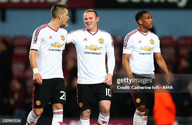 Wayne Rooney of Manchester United with Morgan Schneiderlin of Manchester United after the Emirates FA Cup Sixth Round Replay match between West Ham...