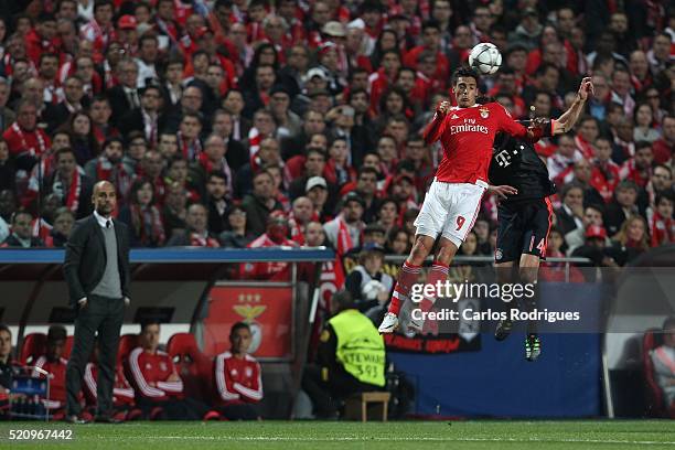 Benfica's forward Raul Jimenez vies with Bayern Munich's midfielder Xabi Alonso during the match between SL Benfica and FC Zenit for the UEFA...