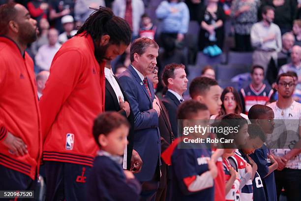 Head coach Randy Wittman of the Washington Wizards listens to the national anthem before the start of their game against the Atlanta Hawks at Verizon...