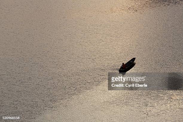 lonely boat on mekong river - cyril eberle stockfoto's en -beelden