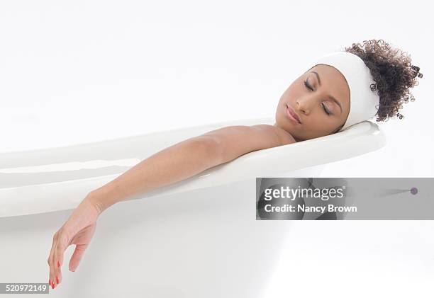 woman in bathtub is sleeping. - african american woman bath stock pictures, royalty-free photos & images