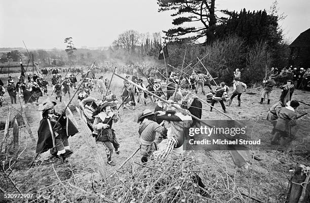 Members of The Sealed Knot reenact a battle from the siege of Basing House, a battle that took place near Basingstoke during 1644, England, 1969. The...