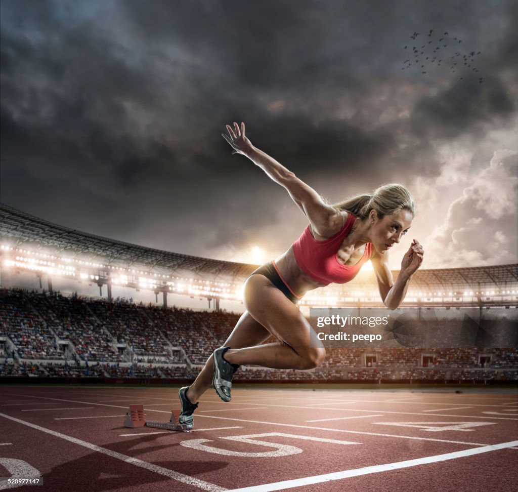 Professional Female Athlete Sprinting Off Blocks