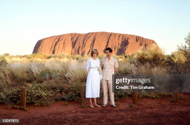 Prince Charles, The Prince Of Wales And Diana, Princess Of Wales Standing In Front Of Ayers Rock During Their Official Tour Of Australia