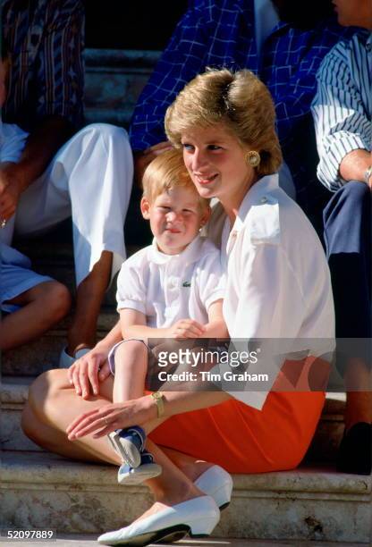 Diana, Princess Of Wales, Sitting On The Steps Of The Marivent Palace With Her Son, Prince Harry, Sitting On Her Lap At A Photocall During Their...