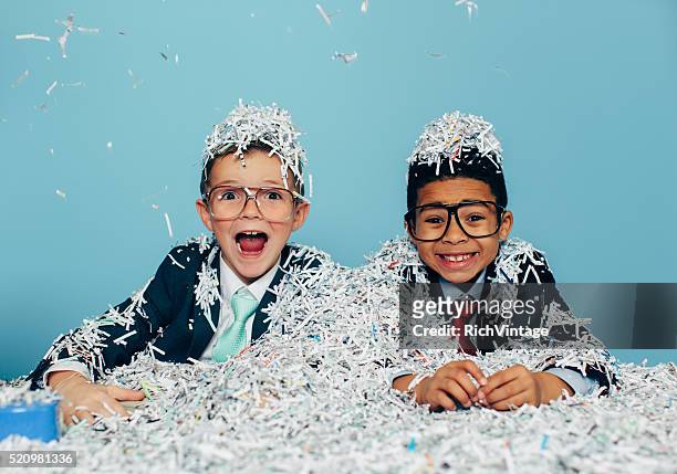 young businessmen partying with shredded paper - shredded paper stock pictures, royalty-free photos & images