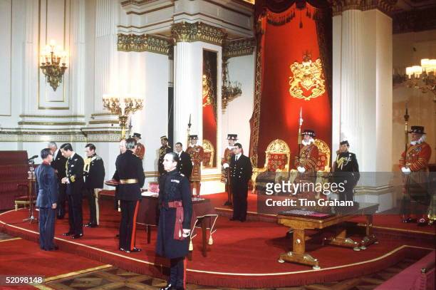 Prince Charles Conducting An Investiture In The Throne Room At Buckingham Palace. With Him In Attendance Are Yeomen Of The Guard In The Throne Room