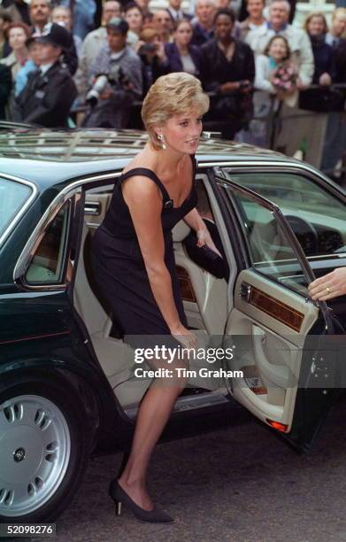 Diana, Princess Of Wales, Pulling Down The Hem Of Her Short Dress As She Alights Her Car For The Film Preview Of 'apollo 13' In London.