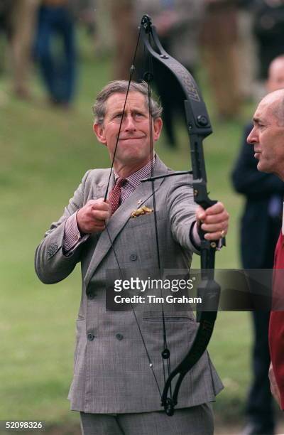 Prince Charles Trying Archery At The Aston Martin Clay Pigeon Shoot In Aid Of The Prince's Trust, The Royal Berkshire Shooting School, Pangbourne,...