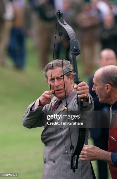 Prince Charles Trying Archery At The Aston Martin Clay Pigeon Shoot In Aid Of The Prince's Trust, The Royal Berkshire Shooting School, Pangbourne,...