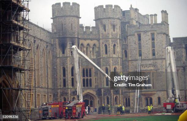 Firemen Inspecting Damage And Extinguishing The Fire That Devastated Parts Of Windsor Castle.