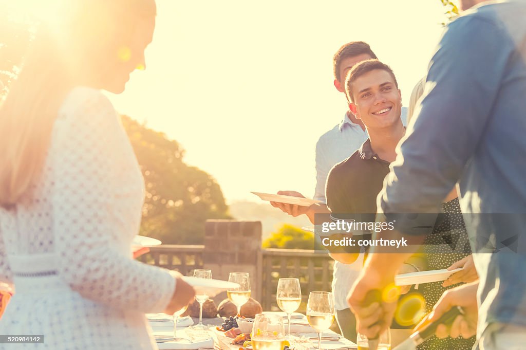 Group of friends eating outdoors.