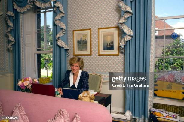 Princess Diana At Her Desk In Her Sitting Room At Home In Kensington Palace, London. Beside Her Is Her School Tuckbox With The Name D.spencer.