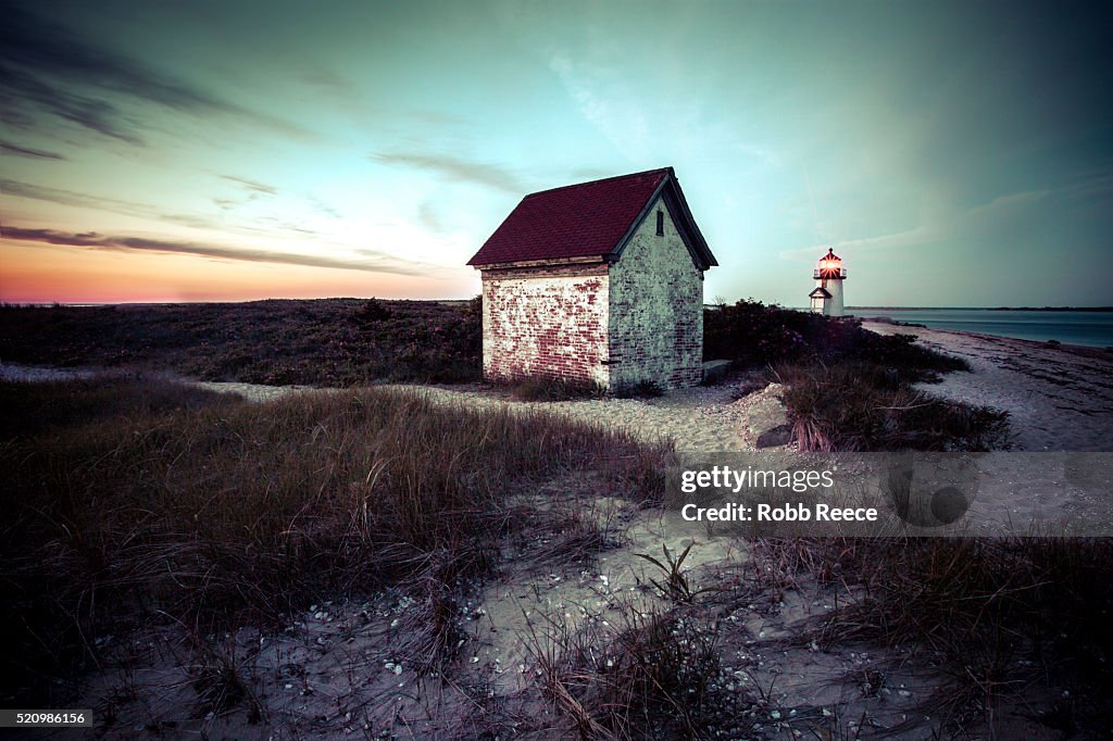 A deserted beach building and Brant Point lighthouse on Nantucket Island