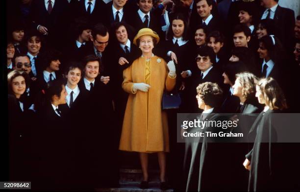 The Queen Surrounded By Students At Evora University During An Official Tour Of Portugal. She Is Wearing A Cloak From The University.