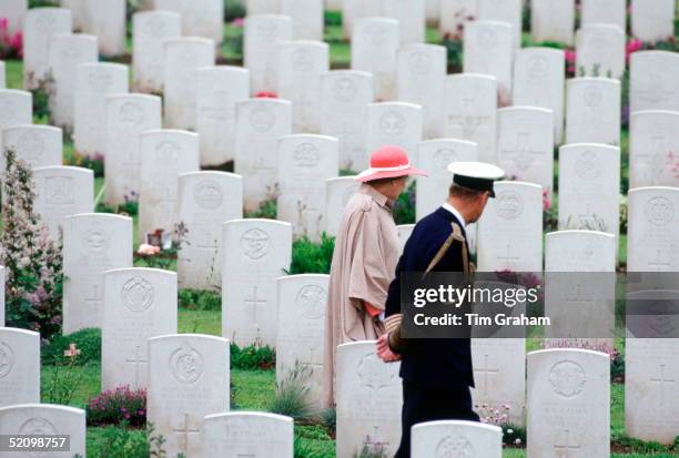 Queen Elizabeth Ll And Her Husband, Prince Philip, Walking Through The Commonwealth War Graves Before Attending A Service For The 50th Anniversary Of...