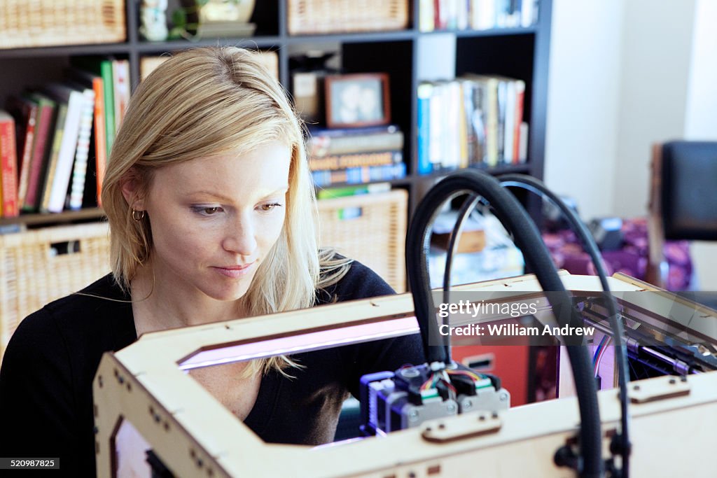 Woman setting up 3D printer