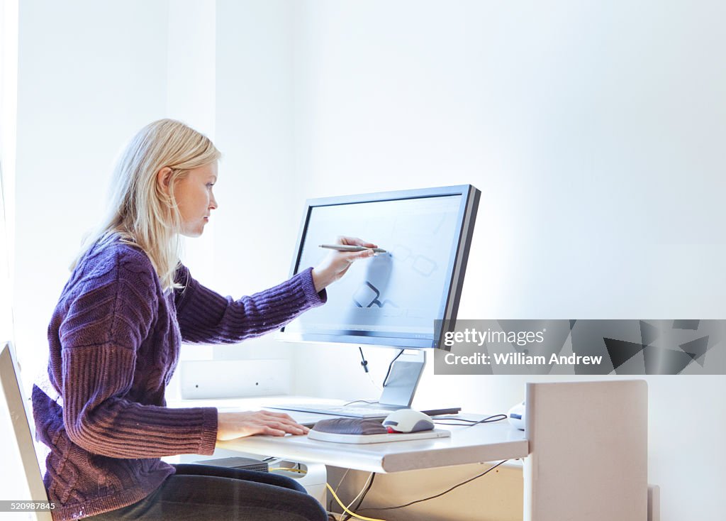 Woman using stylus to adjust 3D design