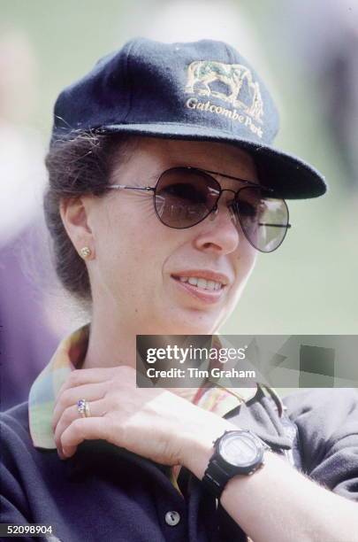 Princess Anne At The Gatcombe Park Horse Trials. The Princess Is Wearing A Baseball Cap With The Gatcombe Park Logo On It. She Is Also Wearing...