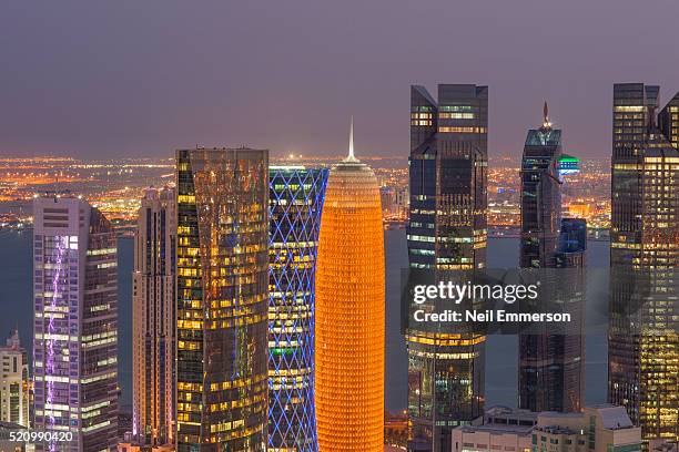 skyline of doha in qatar - doha skyscrapers at night,qatar stock pictures, royalty-free photos & images