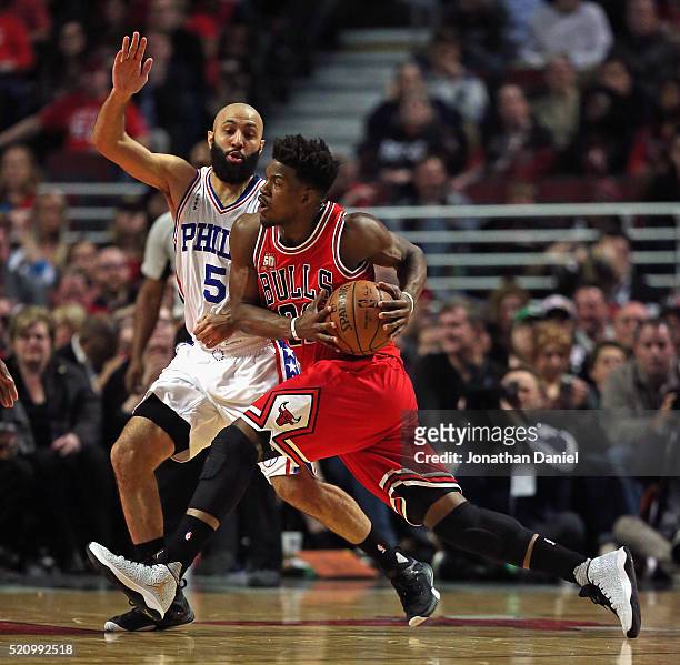 Jimmy Butler of the Chicago Bulls drives against Kendall Marshall of the Philadelphia 76ers at the United Center on April 13, 2016 in Chicago,...