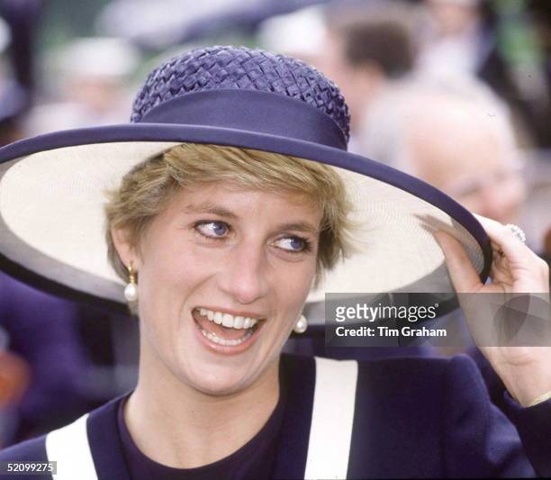 Princess Diana Laughing During Her Visit To Liverpool. She Is Holding The Brim Of Her Hat As It Is A Windy Day.