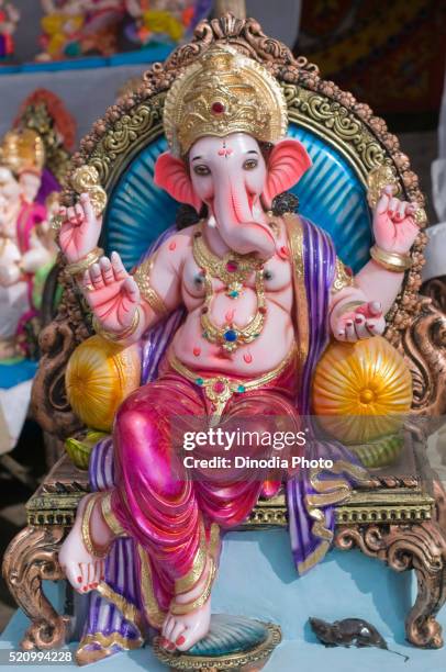 a full length sitting shining and colourful idol of ganesh idols, pune, maharashtra, india, asia - ganesha stock pictures, royalty-free photos & images