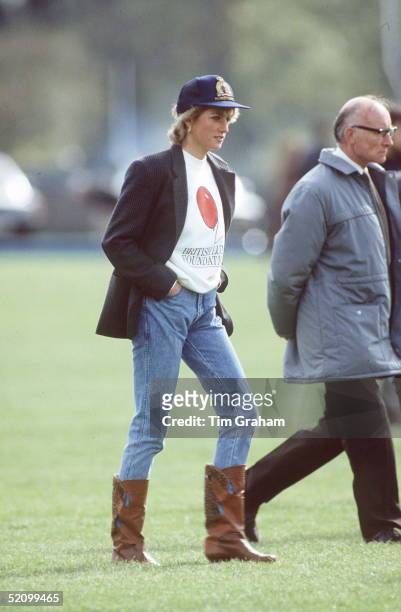 Princess Diana Wearing A British Lung Foundation Sweatshirt, A Baseball Cap, Boots And Jeans To Guards Polo Club In Windsor.