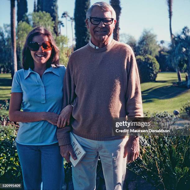 Actor Cary Grant arm in arm with a woman, circa 1978.