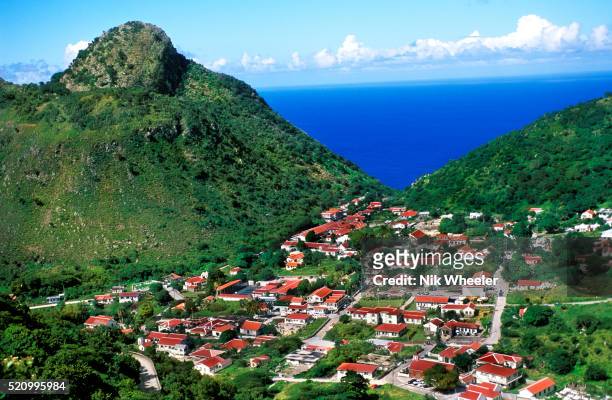 Red roofs of The Bottom, capital of the mountainous island of Saba in the Netherlands Antilles, sits 850 feet above the Caribbean, in the bowl of an...