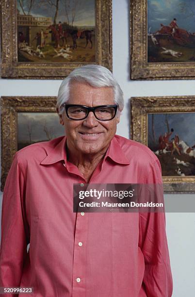 Actor Cary Grant surrounded by hunting scenes, circa 1978.