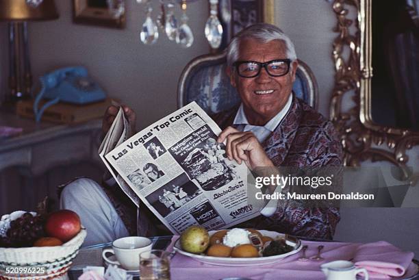 Actor Cary Grant reading the paper at breakfast, 1978.