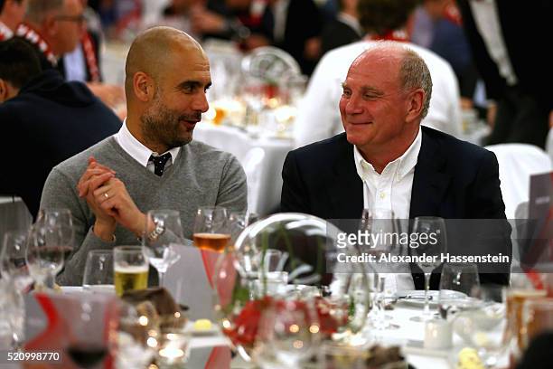 Josep Guardiola , head coach of Muenchen talks to Uli Hoeness during the Champions Banquette at EPIC SANA Lisboa Hotel after winning the UEFA...