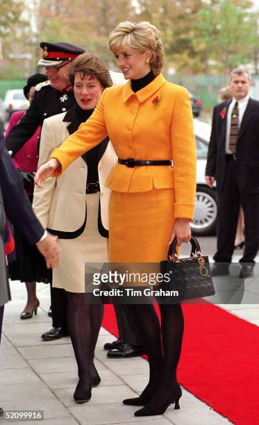 Princess Diana Visiting Liverpool. Diana Is Wearing A Bright Orange Suit Designed By Versace And She Is Carrying A Dior Handbag.
