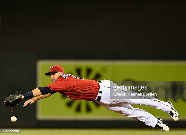 Brian Dozier of the Minnesota Twins dives for a single hit by Jimmy Rollins of the Chicago White Sox during the sixth inning of the game on April 13,...