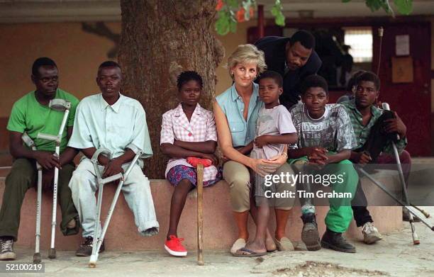 Diana, Princess Of Wales, With Children Injured By Mines At Neves Bendinha Orthopaedic Workshop In Luanda, Angola.