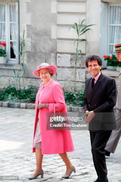 The Queen With Jacques Lang At The Chateau De Blois During An Official Tour Of France. She Is Wearing An Outfit By Fashion Designer Ian Thomas.